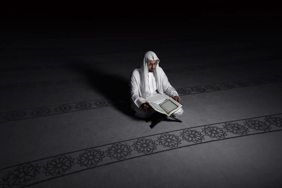 Foto sebuah naskah kuno kitab fiqih muamalah yang terbuka di atas meja kayu perpustakaan Islam klasik dengan pencahayaan hangat yang tenang dan latar belakang rak buku-buku tebal.