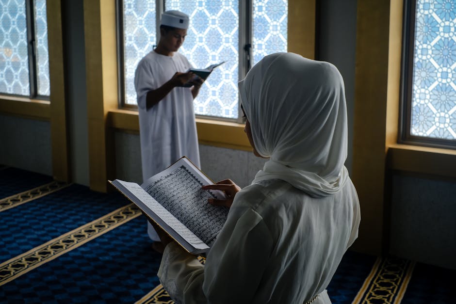 Foto naskah kuno kitab fiqih klasik dengan tulisan tangan Arab yang indah, diletakkan di atas meja kayu jati di dalam perpustakaan tua yang dipenuhi rak buku-buku turats dan pencahayaan lampu kuning yang tenang.