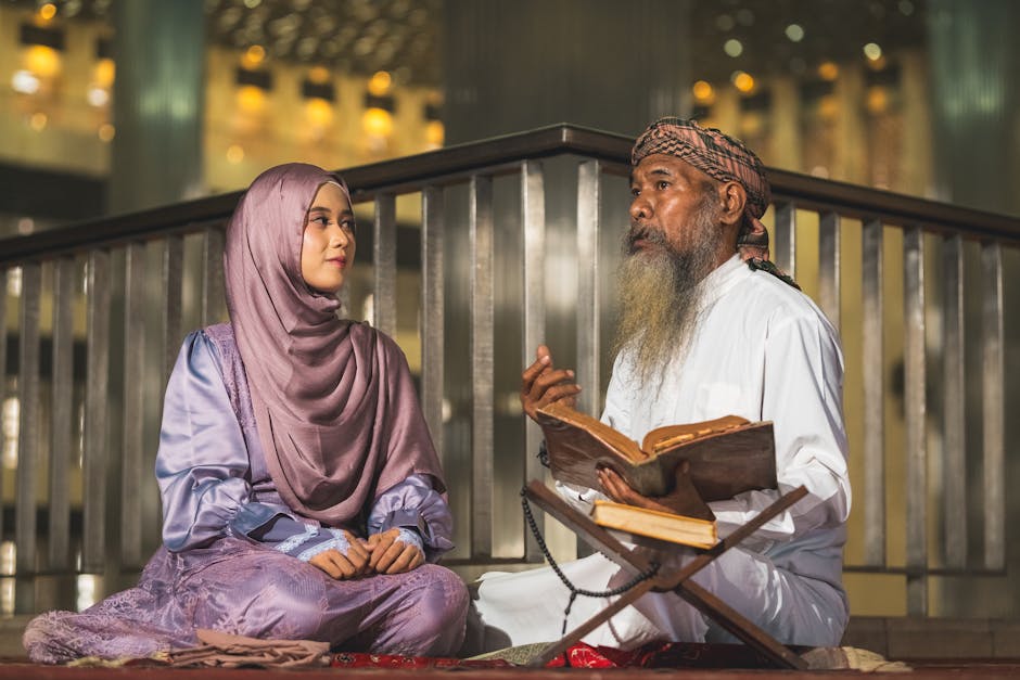 Foto sebuah mushaf Al-Quran yang terbuka di atas meja kayu di dalam perpustakaan masjid yang tenang, dengan cahaya matahari pagi yang lembut masuk melalui jendela, menciptakan suasana khidmat dan ilmiah.