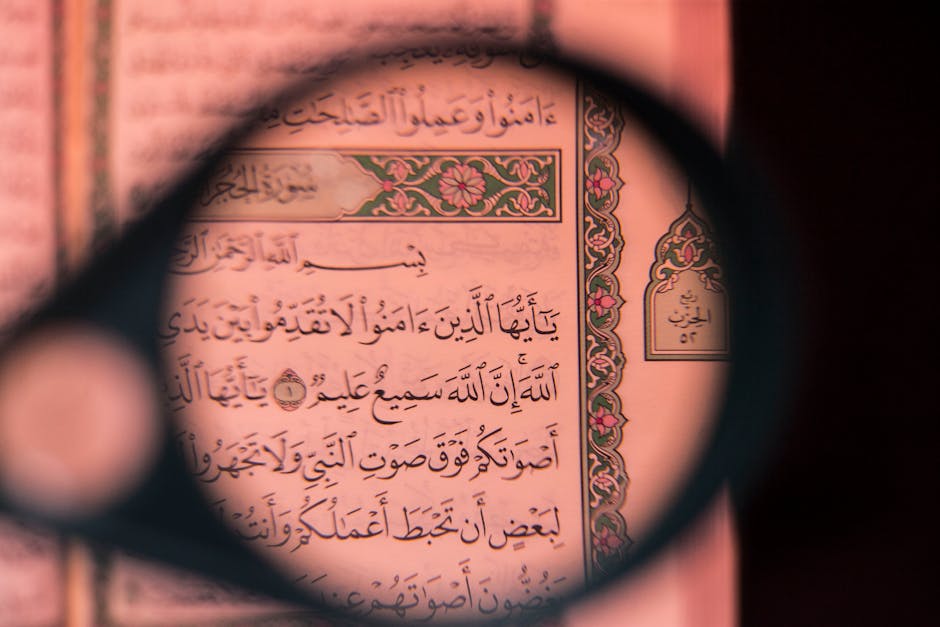 Foto sebuah mushaf Al-Quran terbuka dengan pencahayaan lembut di dalam sebuah perpustakaan klasik yang penuh dengan kitab-kitab turats, menciptakan suasana keilmuan yang dalam dan tenang.